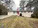 Cozy single-story home featuring a bright red front door and a well-maintained lawn at 4954 Springbrook Dr, Douglasville, GA 30135