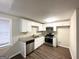 Modern kitchen with stainless steel appliances, granite countertops, and white cabinetry at 4954 Springbrook Dr, Douglasville, GA 30135