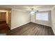 Inviting living room with laminate floors, ceiling fan, and an entry door with a window at 4954 Springbrook Dr, Douglasville, GA 30135