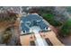 Bird's eye view of a luxury home with a manicured lawn, elegant driveway, and scenic surroundings at 740 Bethpage Dr, Mcdonough, GA 30253