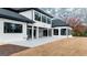 Rear exterior featuring a concrete patio, black framed windows, and ample space for outdoor activities at 740 Bethpage Dr, Mcdonough, GA 30253