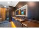 Modern bathroom with floating vanity, stone sinks and large, lighted mirror at 740 Bethpage Dr, Mcdonough, GA 30253