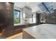 Modern kitchen featuring a marble backsplash, marble island, sleek cabinetry, and stainless steel appliances at 740 Bethpage Dr, Mcdonough, GA 30253