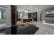 Open concept kitchen with glossy cabinets, marble countertops, and elegant lighting fixtures at 740 Bethpage Dr, Mcdonough, GA 30253