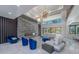Spacious living room with a stone fireplace, modern lighting, and floor-to-ceiling windows at 740 Bethpage Dr, Mcdonough, GA 30253