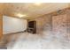 Unfinished basement area with brick accent wall and storage shelving at 3411 Airline Rd, Mcdonough, GA 30252