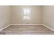 Bedroom with a single window, light colored walls, and luxury vinyl plank flooring at 3411 Airline Rd, Mcdonough, GA 30252