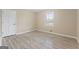 Neutral bedroom featuring light colored walls, luxury vinyl plank flooring, and a window at 3411 Airline Rd, Mcdonough, GA 30252