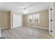 Bright bedroom featuring laminate flooring, neutral paint, a ceiling fan, and double windows at 3411 Airline Rd, Mcdonough, GA 30252