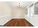 Dining room with classic hardwood floors, chandelier lighting, and built-in cabinets offering ample storage at 3411 Airline Rd, Mcdonough, GA 30252