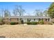 Classic brick home with a symmetrical facade, showcasing a well-maintained lawn and inviting covered entry at 3411 Airline Rd, Mcdonough, GA 30252