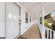 Inviting covered front porch featuring white pillars, ceiling fans, and ample space for relaxing or greeting guests at 3411 Airline Rd, Mcdonough, GA 30252