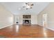 Large living room with hardwood flooring, a ceiling fan, and a beautiful stone fireplace at 3411 Airline Rd, Mcdonough, GA 30252