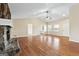 Expansive living room with hardwood floors, featuring a stone fireplace and large windows for natural light at 3411 Airline Rd, Mcdonough, GA 30252