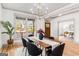 Inviting dining room with wood floors and views of the front yard and home entrance at 1055 Ormewood Se Ave, Atlanta, GA 30316