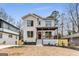 Two-story house with white brick, wood porch, and manicured landscaping at 1055 Ormewood Se Ave, Atlanta, GA 30316