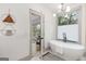 Charming bathroom features a bathtub, modern fixtures, and an open door leading to another room at 1055 Ormewood Se Ave, Atlanta, GA 30316