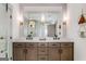 Modern bathroom boasts a double vanity with stone countertop and a view of the shower and toilet area at 1055 Ormewood Se Ave, Atlanta, GA 30316