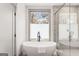 Bright bathroom featuring a modern tub with black faucet and large window at 1055 Ormewood Se Ave, Atlanta, GA 30316