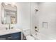 Bathroom with gold fixtures, blue vanity and tile in shower at 1055 Ormewood Se Ave, Atlanta, GA 30316