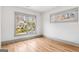 Bright bedroom with hardwood floors, large windows offering a view of neighborhood at 1055 Ormewood Se Ave, Atlanta, GA 30316