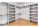 Walk-in closet with wood floors features ample shelving and custom storage for all your wardrobe needs at 1055 Ormewood Se Ave, Atlanta, GA 30316