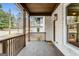 Covered front porch with wooden features and access to the front door at 1055 Ormewood Se Ave, Atlanta, GA 30316