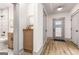 Hallway view with access to the bathroom with wooden cabinet and the exterior door at 1055 Ormewood Se Ave, Atlanta, GA 30316