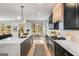 Modern kitchen with stainless steel appliances, a waterfall island, and an adjacent dining area at 1055 Ormewood Se Ave, Atlanta, GA 30316