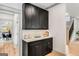 Kitchen storage with white countertops, and black cabinets with brass handles at 1055 Ormewood Se Ave, Atlanta, GA 30316