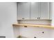 Well-lit laundry room boasts custom cabinets, countertop, and washer/dryer hookups for added convenience at 1055 Ormewood Se Ave, Atlanta, GA 30316