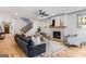 Comfortable living room with fireplace, wood floors, a modern fan, and staircase at 1055 Ormewood Se Ave, Atlanta, GA 30316