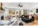 Bright living room with gray sectional, modern ceiling fan, and stylish decor at 1055 Ormewood Se Ave, Atlanta, GA 30316