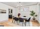 Bright dining room featuring wood floors, modern lighting, and views of the kitchen at 1055 Ormewood Se Ave, Atlanta, GA 30316