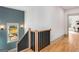 Staircase with a wood and metal railing ascends past a stylish wall with vertical paneling and a window at 1055 Ormewood Se Ave, Atlanta, GA 30316