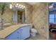 Well-lit bathroom featuring patterned wallpaper, toilet, white cabinets and countertop with a sink at 500 Nicole Ct Se, Conyers, GA 30094