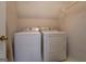 Laundry room featuring a washer and dryer with white appliances and wire shelving at 500 Nicole Ct Se, Conyers, GA 30094