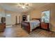 A spacious bedroom features wood-look floors, neutral paint, a ceiling fan, and plentiful closet space at 500 Nicole Ct Se, Conyers, GA 30094