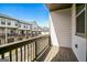 Balcony showcasing neighborhood townhomes with wood railings and exterior siding at 2624 Caruso Way, Atlanta, GA 30339