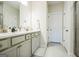 Bright bathroom featuring a double sink vanity with quartz countertop and neutral-toned cabinetry at 2624 Caruso Way, Atlanta, GA 30339