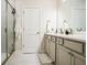 Well-lit bathroom featuring double sinks, a glass-enclosed shower, and modern fixtures at 2624 Caruso Way, Atlanta, GA 30339