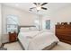 Comfortable bedroom featuring soft carpet, two windows, and wooden furniture at 2624 Caruso Way, Atlanta, GA 30339