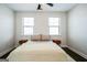 Airy bedroom with hardwood floors, a plush blanket, and two large windows at 2624 Caruso Way, Atlanta, GA 30339