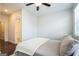 Neat bedroom with hardwood floors, a ceiling fan, and ensuite bathroom access at 2624 Caruso Way, Atlanta, GA 30339