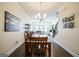 Open-concept dining room with dark hardwood floors, modern lighting, seamlessly connects living spaces at 2624 Caruso Way, Atlanta, GA 30339