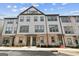 Exterior view of a new townhome building, highlighting the brick and siding design at 2624 Caruso Way, Atlanta, GA 30339