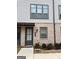 Charming townhouse with a gray brick facade, a dark front door, and well-maintained landscaping at 2624 Caruso Way, Atlanta, GA 30339