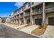 Long row of modern townhomes with driveways, garages, and balconies at 2624 Caruso Way, Atlanta, GA 30339