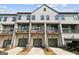 Townhomes with garages and balconies, showcasing modern design and ample parking at 2624 Caruso Way, Atlanta, GA 30339