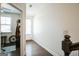 Hallway with hardwood floors leads to a naturally lit room with bike equipment at 2624 Caruso Way, Atlanta, GA 30339